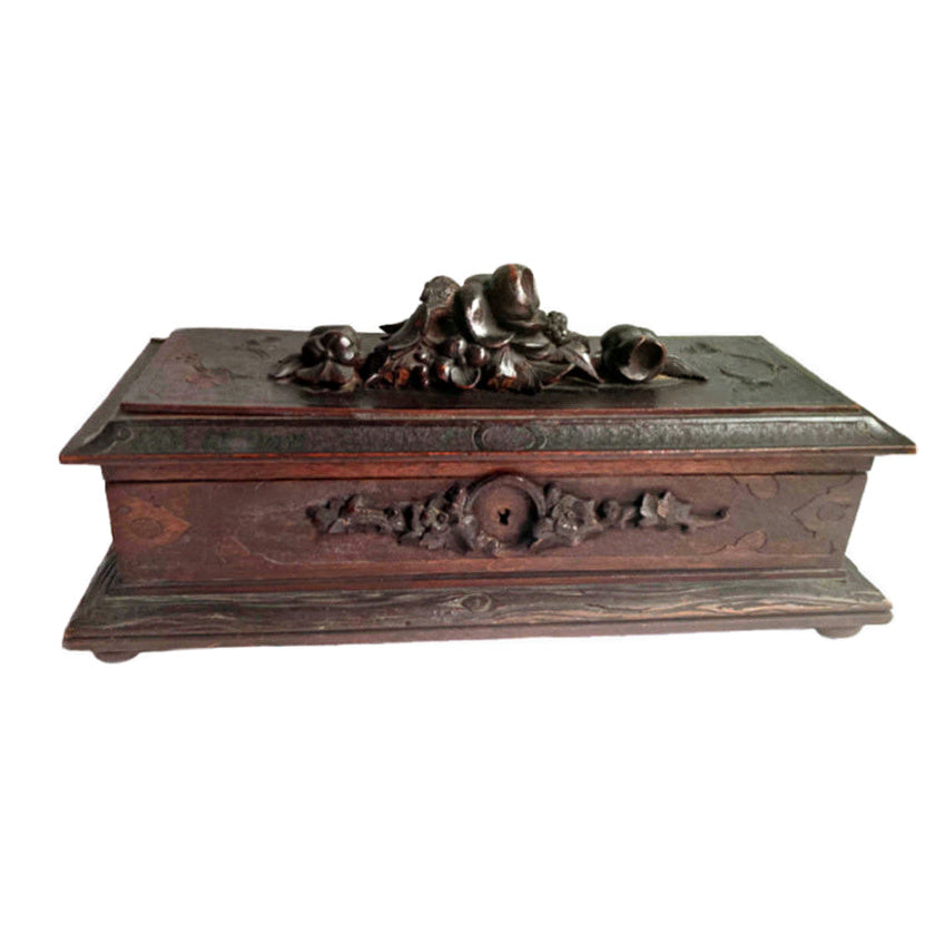 Antique French Black Forest hand-carved wooden jewelry or glove box with a floral top and a key hole on the front.