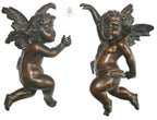 Close detail of hand carved antique wooden putto showing carved feathers and cherubic face