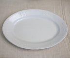 close up antique platter rim detail leaf and berry border aged ironstone glaze texture