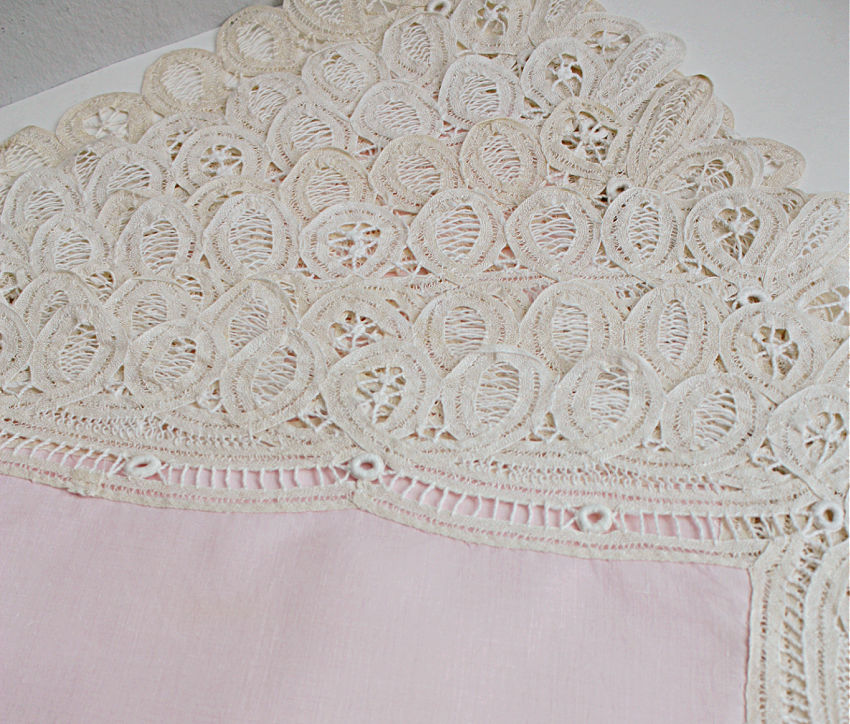 Close view of intricate handmade Battenberg tape lace embroidery