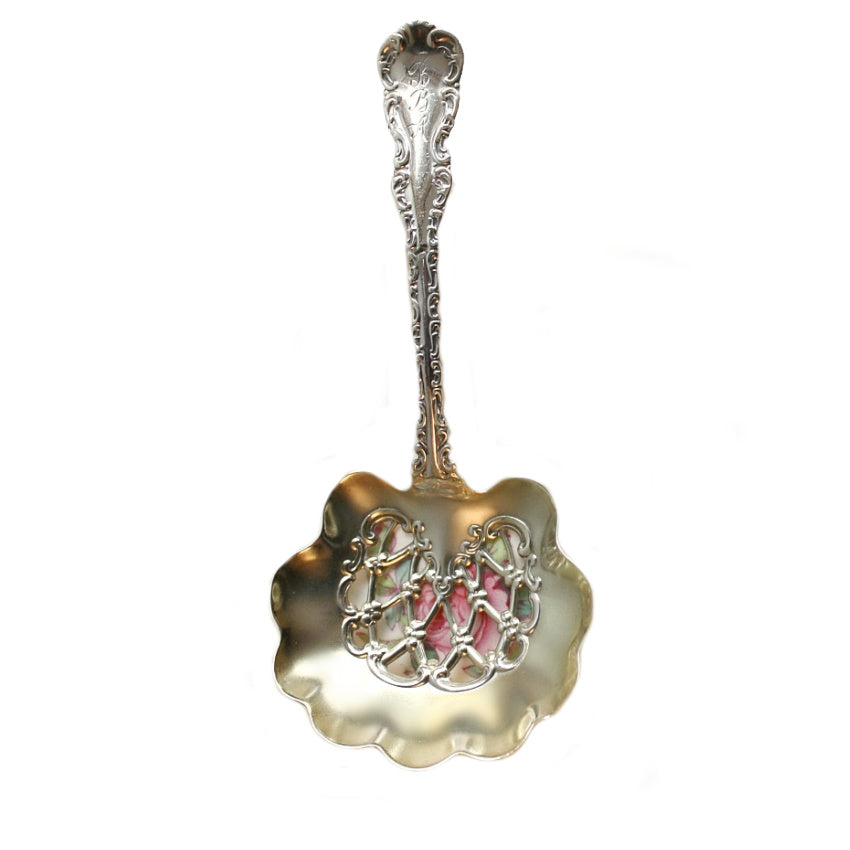 antique sterling silver bonbon spoon on rose plate