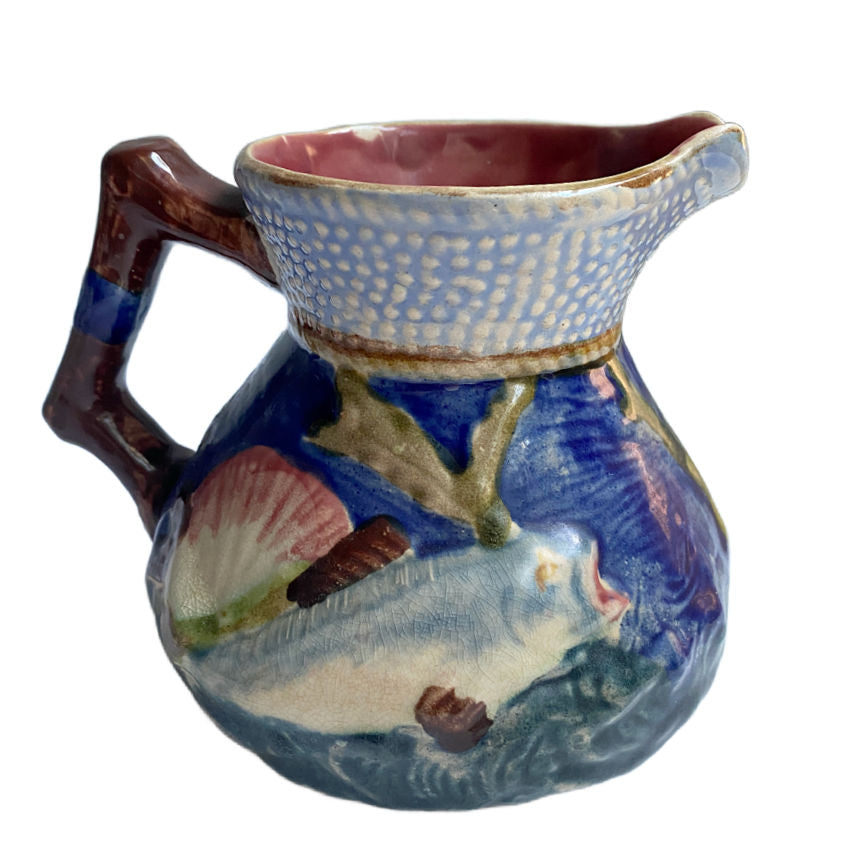 Charming English Majolica pitcher by Shorter & Sons, with raised fish and shell design in ocean hues—Staffordshire coastal beauty.