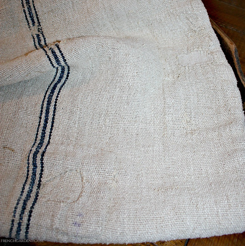 Gorgeous heavy weight Antique French Hand Woven Linen Grain Sack, of the most delicious oatmeal color, with a triple blue stripe. with patches