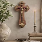 French antique crucifix wall display with bronze Corpus, white flowers in French pottery, antique books, and candlelight