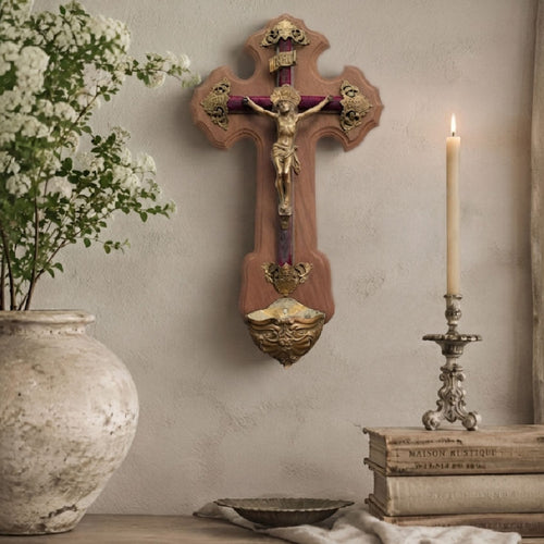 French antique crucifix wall display with bronze Corpus, white flowers in French pottery, antique books, and candlelight