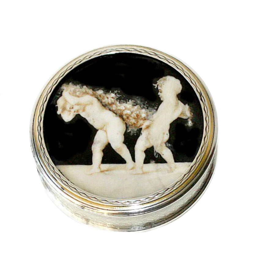 Antique French sterling silver snuff box lid featuring hand-painted cherubs on a black background with a silver border.