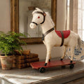 Antique cream horse displayed on French Country cabinet