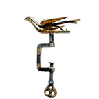 Side view of Victorian brass sewing bird with articulated beak and steel clamp