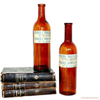 Close detail of antique amber glass bottles with rich patina and glow
