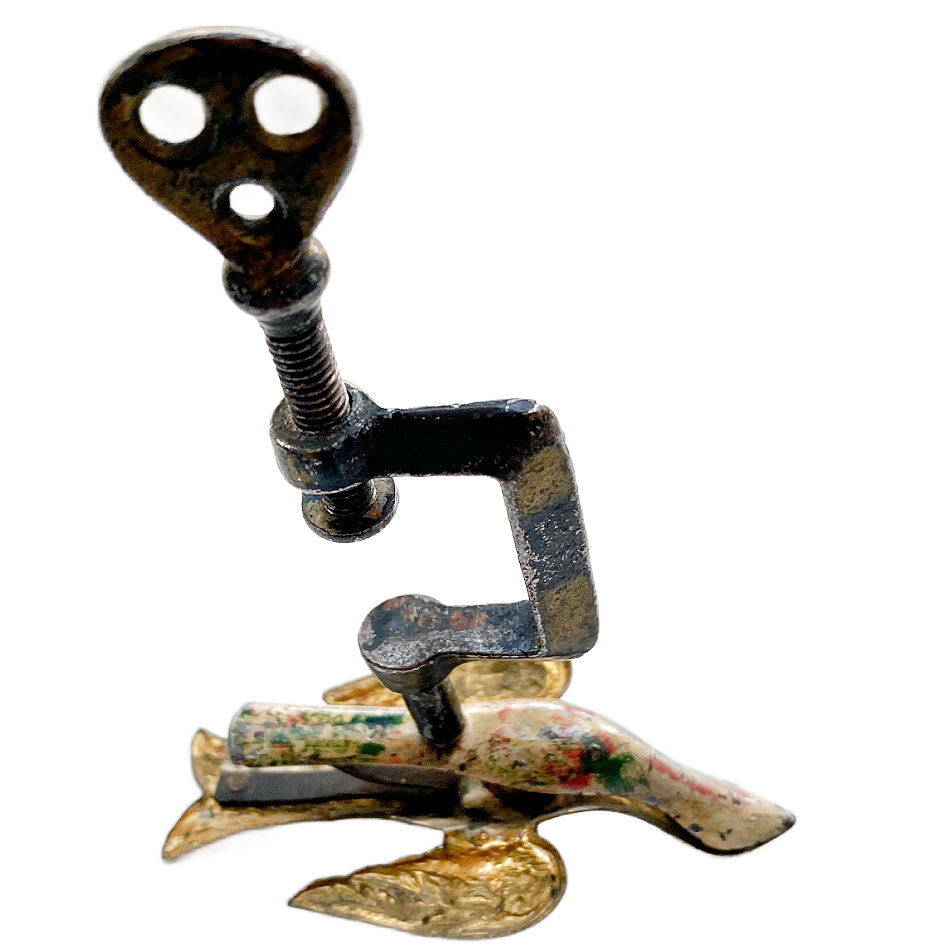 Antique sewing bird showing painted  body, gold-toned wings and tail