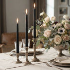 Hand-poured black beeswax taper candles styled on an elegant dining table with flowers