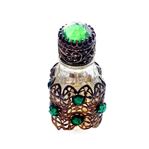Exquisite Art Deco miniature perfume bottle adorned with emerald glass jewels and intricate gilt filigree. A romantic collector’s treasure of timeless elegance.
