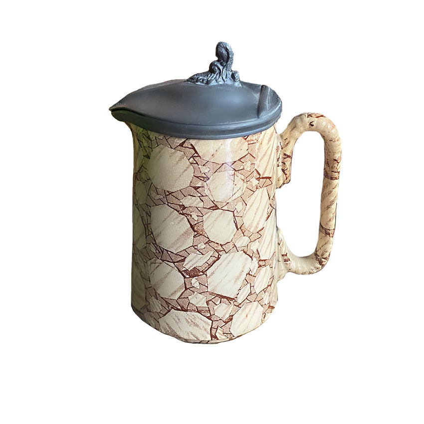 Antique ironstone syrup pitcher with pewter lid featuring a caning transfer design.
