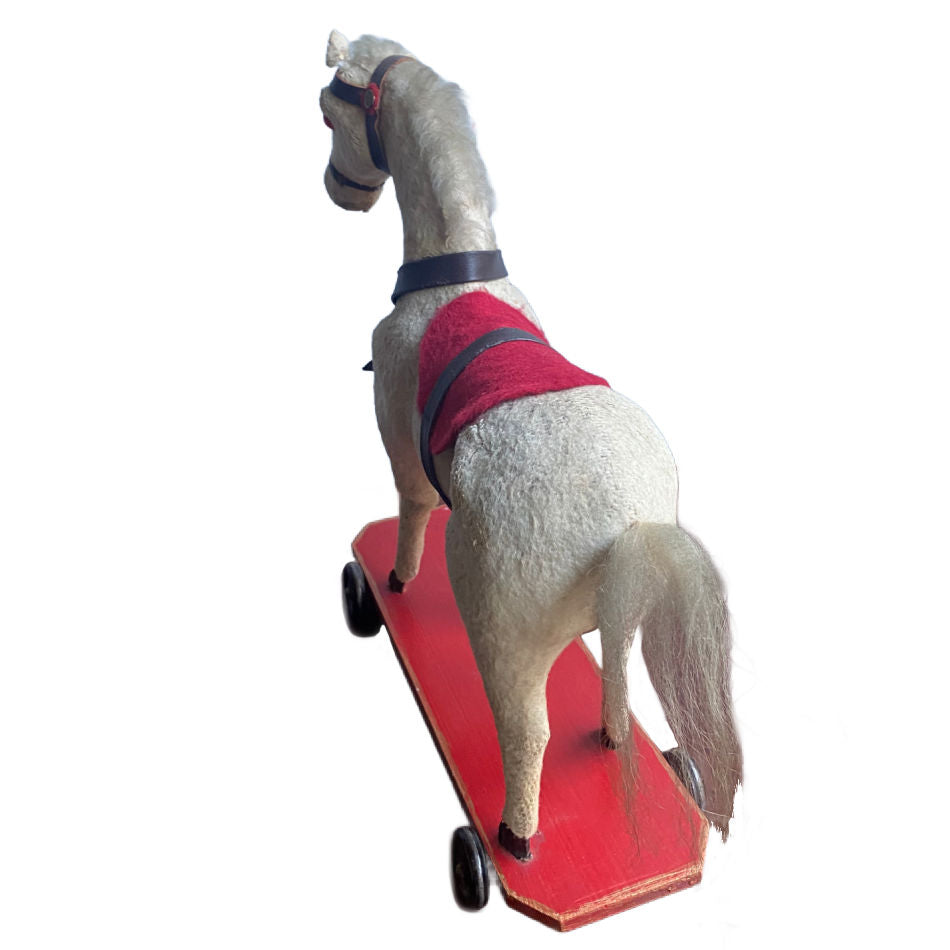 Antique fabric covered horse pull toy with leatherette bridle tail detail