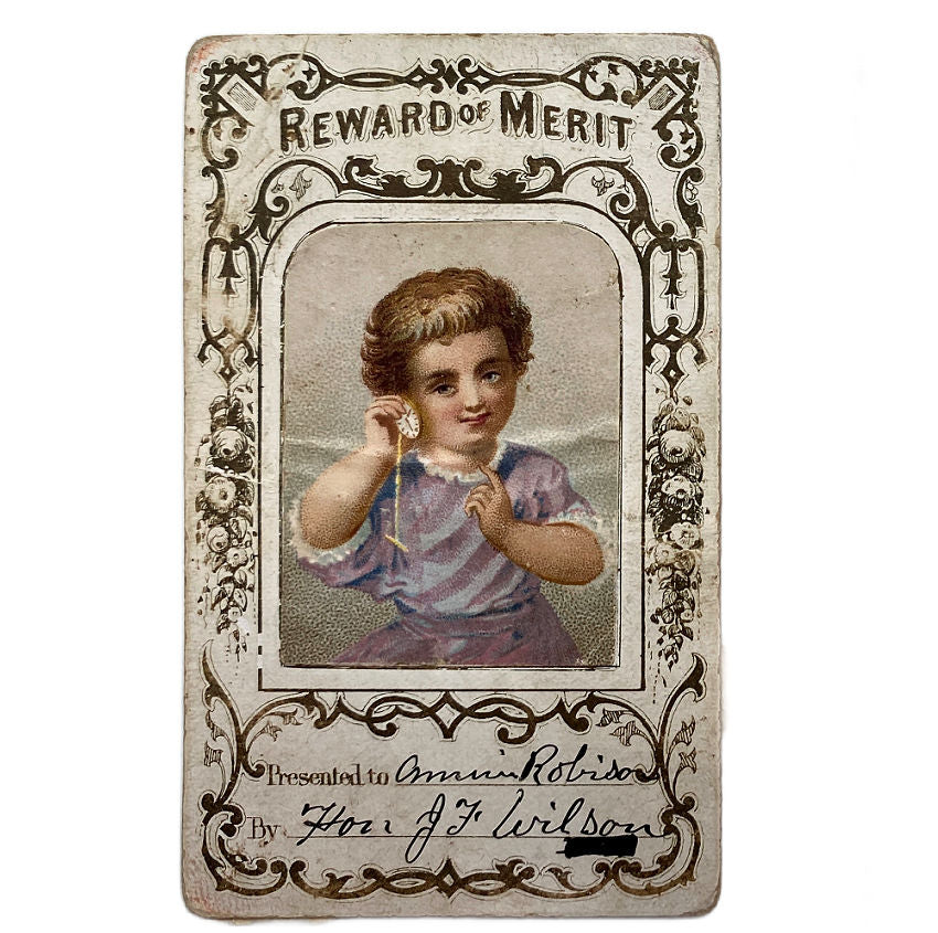 Three vintage 'Reward of Merit' cards featuring children on a white background