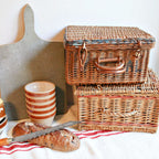 Detail of the basket’s original handle and aged patina shown with champagne basket and handle, olive bowls and cutting board in French kitchen scene