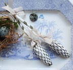 French lavender sachet wands for linens and drawers on an antique blue and white platter with a birds nest and eggs