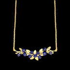 Blueberry bar necklace in patinated bronze, horizontal botanical berry pendant with nature-inspired detail, perfect for modern layered jewelry styling close up uf hand made glass blueberries and gold chain