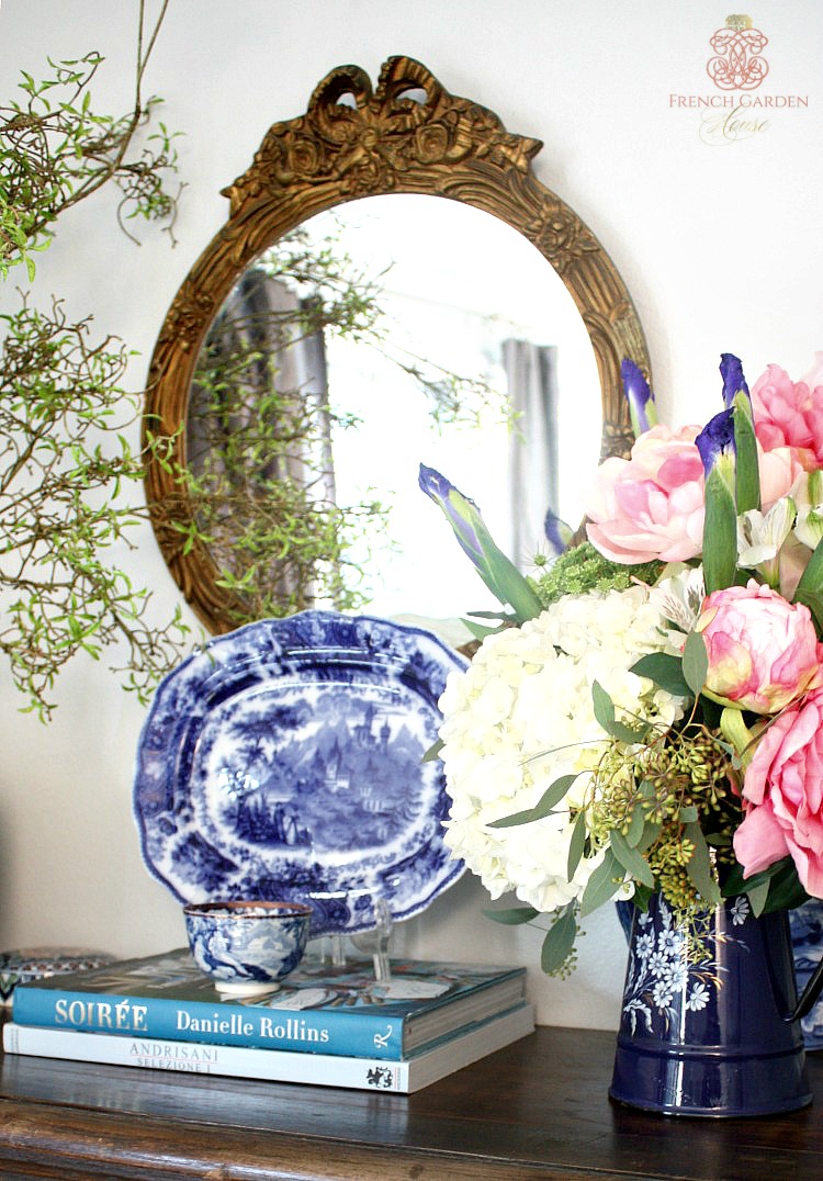 mantel decorated with pink peonies in French enamelware