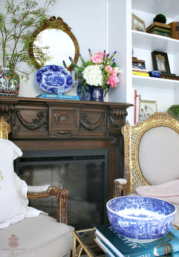 sitting area in master bedroom with built ins and french antique gilt chairs