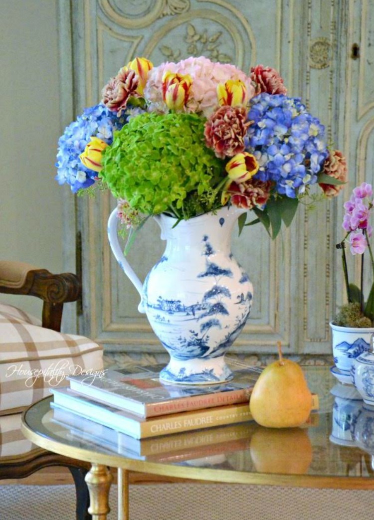 green and blue hydrangeas in delft vase