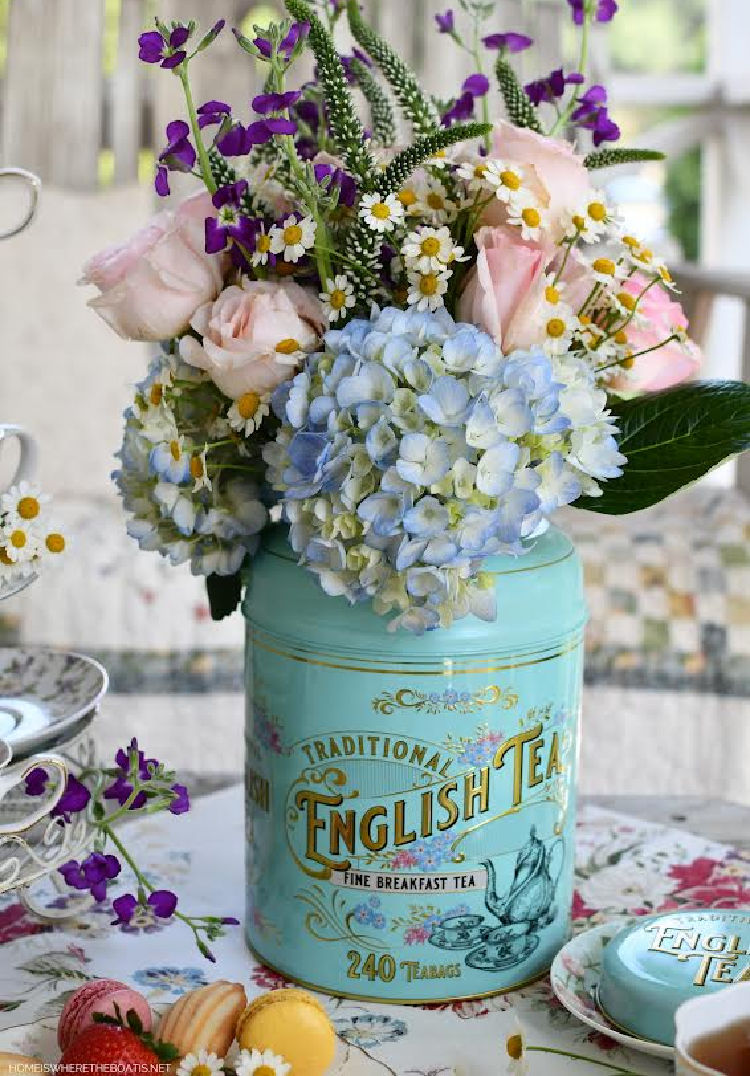 floral arrangement in aqua tea tin