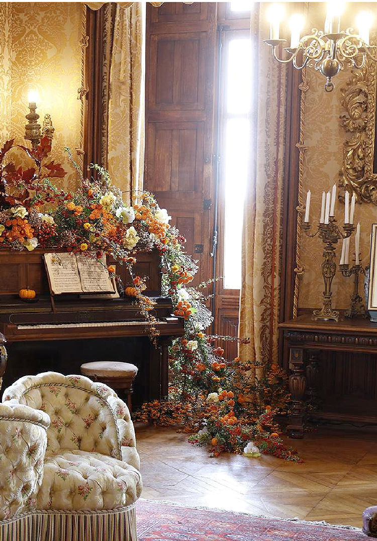 Grand piano covered in flowers at French chateau